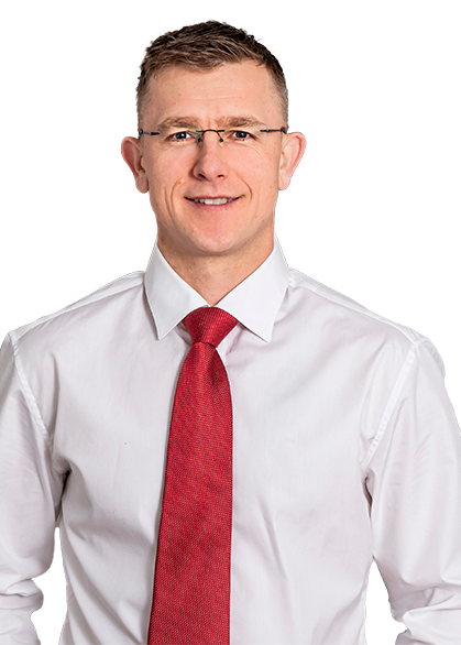 Head shot of Matt Nelson wearing a white button down shirt and red tie